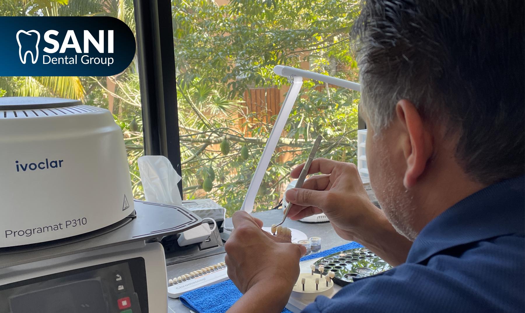 sani_dental_group_all_on_4_dental_implants_mexico_dental_lab_prosthesis Dental technician fabricating a full arch prosthesis for All-on-4 dental implants in Mexico using advanced laboratory technology.